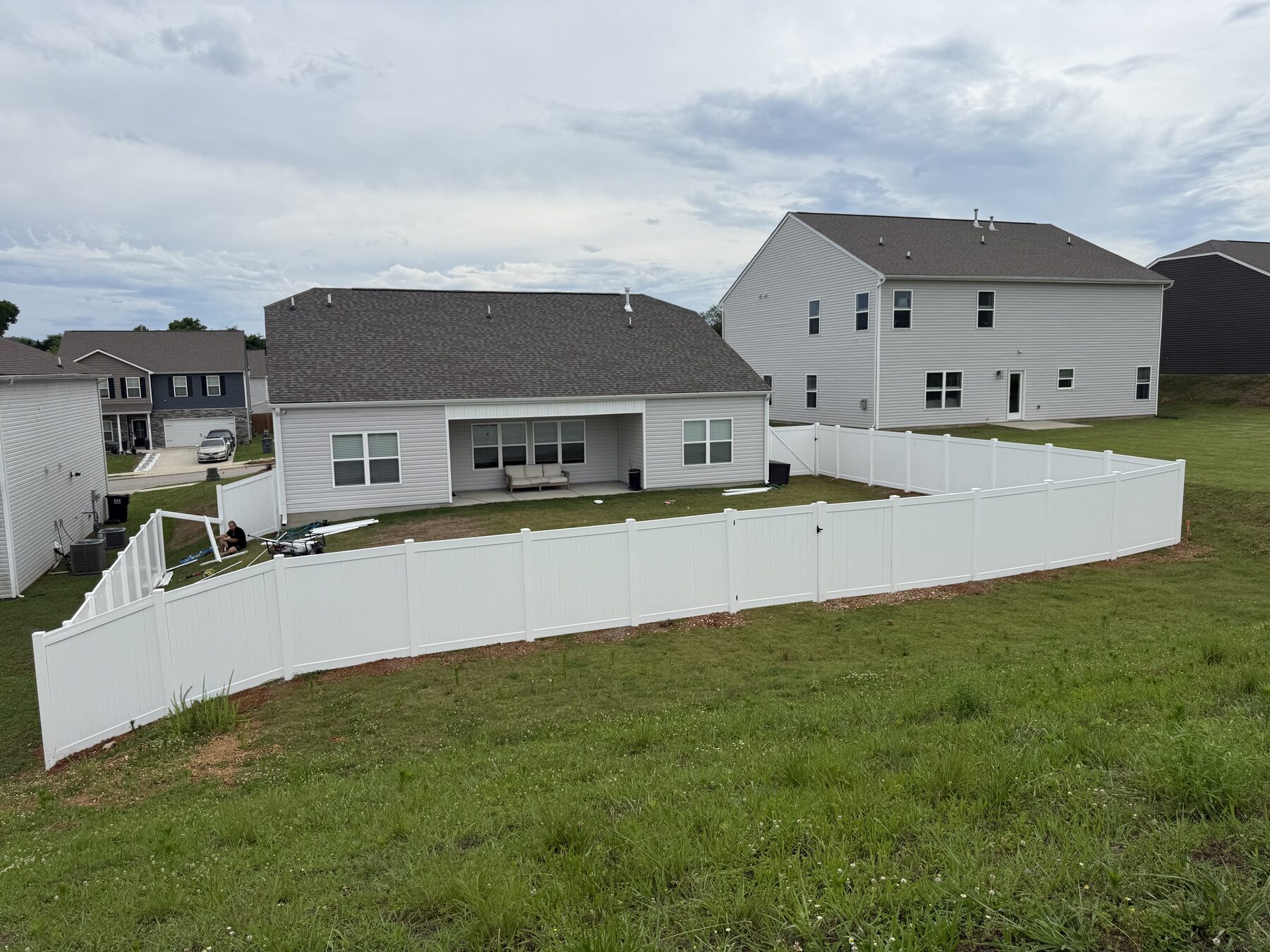 Full-property white vinyl privacy fence